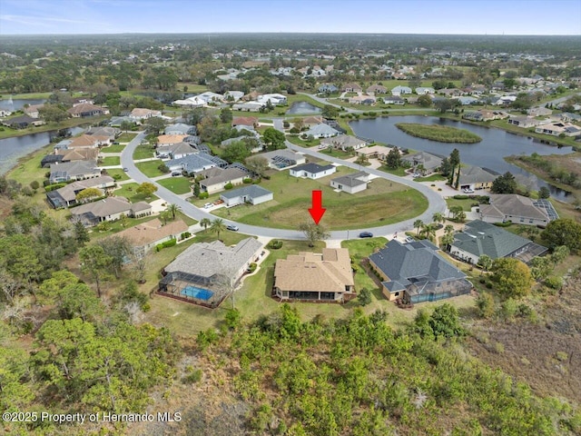 drone / aerial view featuring a residential view and a water view