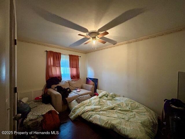 bedroom with a ceiling fan and wood finished floors