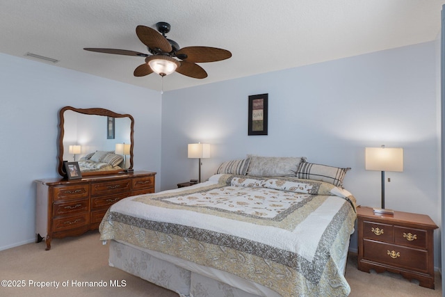 carpeted bedroom featuring visible vents and ceiling fan