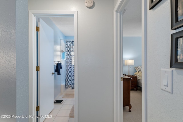 hall featuring tile patterned flooring