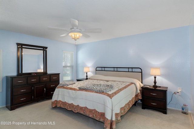 bedroom with light colored carpet, a ceiling fan, and baseboards