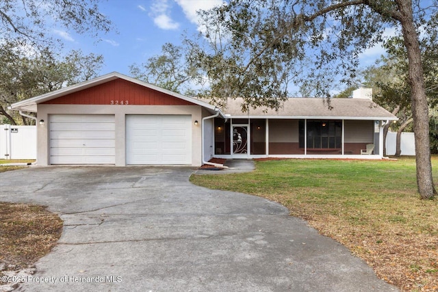 single story home featuring an attached garage, fence, driveway, a chimney, and a front yard