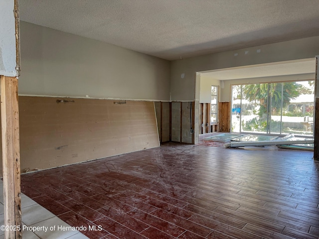 spare room featuring a textured ceiling and wood finished floors