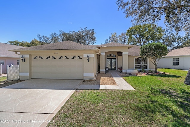 single story home with an attached garage, french doors, driveway, and stucco siding