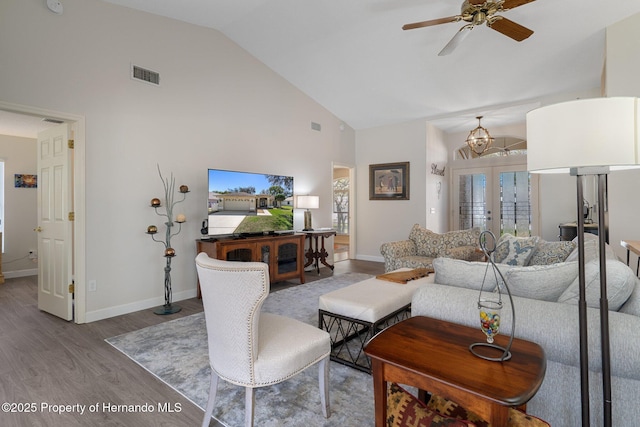 living room featuring visible vents, a healthy amount of sunlight, french doors, wood finished floors, and high vaulted ceiling