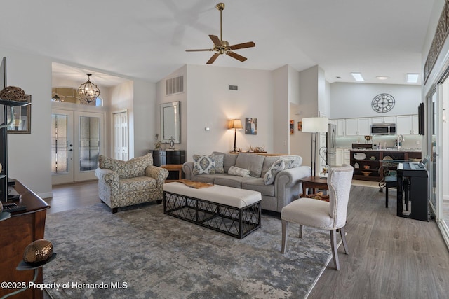 living area featuring visible vents, high vaulted ceiling, wood finished floors, and french doors