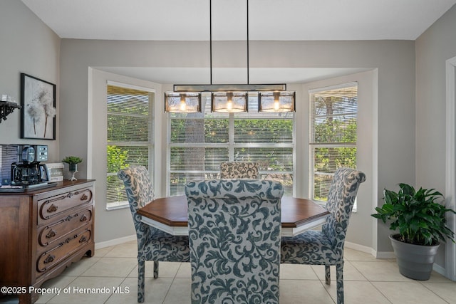 dining space with baseboards and light tile patterned flooring