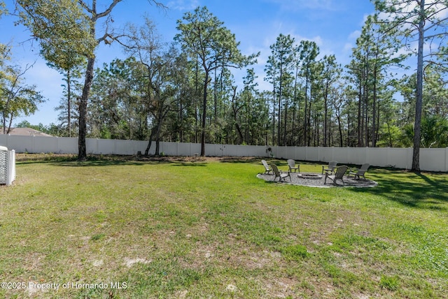 view of yard with an outdoor fire pit and fence