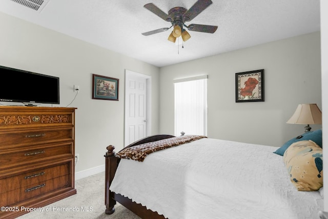 bedroom featuring visible vents, light carpet, ceiling fan, a textured ceiling, and baseboards