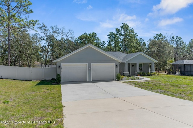 view of front of house with concrete driveway, an attached garage, a gate, fence, and a front yard