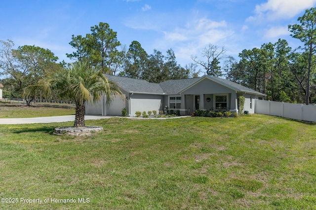 ranch-style house featuring a garage, fence, concrete driveway, stucco siding, and a front lawn