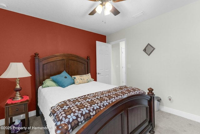 bedroom with light carpet, baseboards, visible vents, and ceiling fan