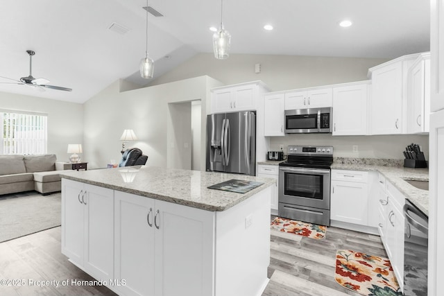 kitchen featuring light wood-style floors, open floor plan, white cabinets, appliances with stainless steel finishes, and a center island