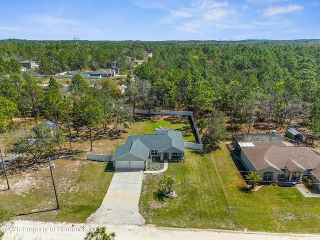 drone / aerial view featuring a wooded view