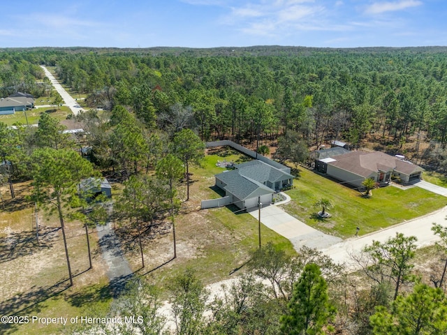 birds eye view of property featuring a view of trees