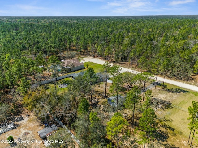 bird's eye view with a wooded view