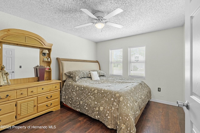 bedroom featuring a ceiling fan, baseboards, dark wood-style flooring, and a textured ceiling