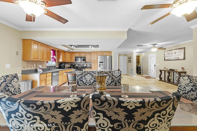 living room with crown molding, light tile patterned floors, and a textured ceiling