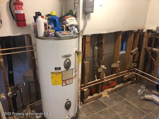 utility room featuring electric water heater