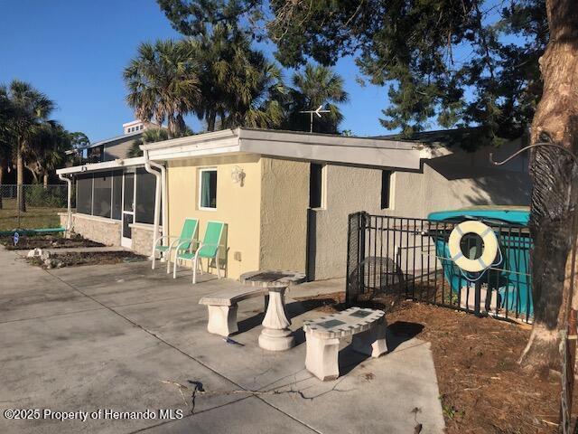 exterior space with a sunroom and fence