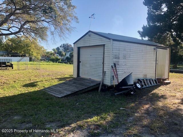 view of outdoor structure with an outbuilding and fence