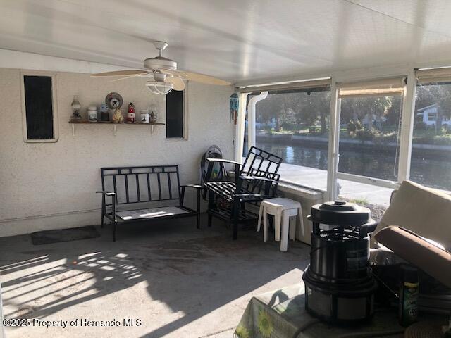 sunroom / solarium featuring ceiling fan