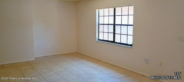 12437 Drayton Dr, Spring Hill, FL 34609 - tiled empty room with baseboards