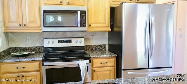 12437 Drayton Dr, Spring Hill, FL 34609 - kitchen with stainless steel appliances, backsplash, dark stone countertops, and light brown cabinetry