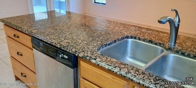 12437 Drayton Dr, Spring Hill, FL 34609 - kitchen featuring dark stone countertops, stainless steel dishwasher, and a sink