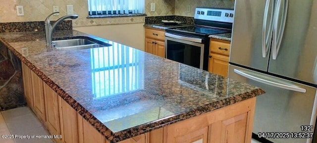 12437 Drayton Dr, Spring Hill, FL 34609 - kitchen with dark stone counters, tasteful backsplash, a sink, light brown cabinetry, and appliances with stainless steel finishes