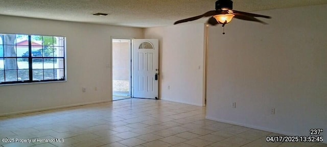 12437 Drayton Dr, Spring Hill, FL 34609 - unfurnished room with a textured ceiling, a ceiling fan, and baseboards