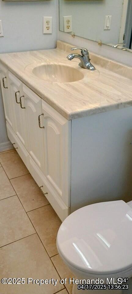12437 Drayton Dr, Spring Hill, FL 34609 - bathroom with vanity and tile patterned flooring