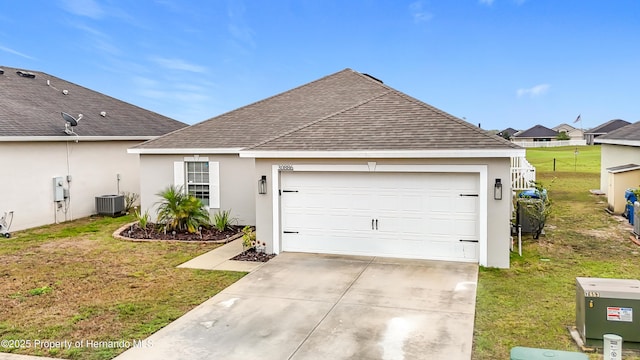 ranch-style home featuring a shingled roof, concrete driveway, a front yard, stucco siding, and an attached garage