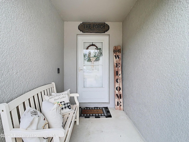 property entrance featuring stucco siding