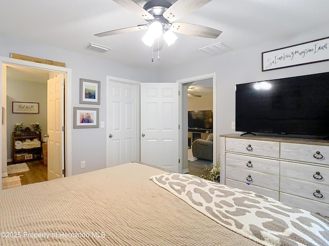 bedroom with a closet, visible vents, and ceiling fan