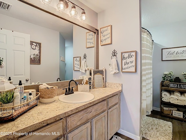 full bathroom with visible vents, baseboards, and vanity