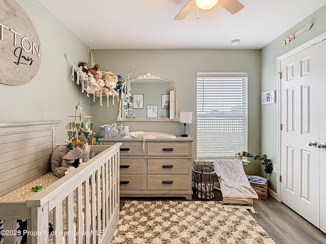 bedroom with light wood-style flooring and ceiling fan