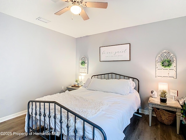 bedroom featuring visible vents, ceiling fan, baseboards, and wood finished floors