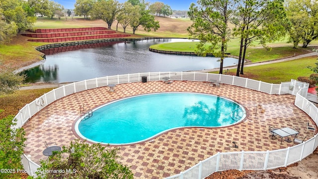 view of swimming pool with a fenced in pool, a water view, a patio, and fence