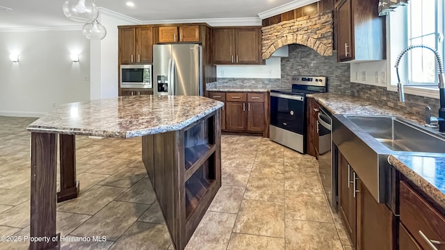 kitchen with a kitchen island, crown molding, custom exhaust hood, stainless steel appliances, and a sink