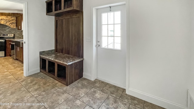 mudroom with light tile patterned floors and baseboards