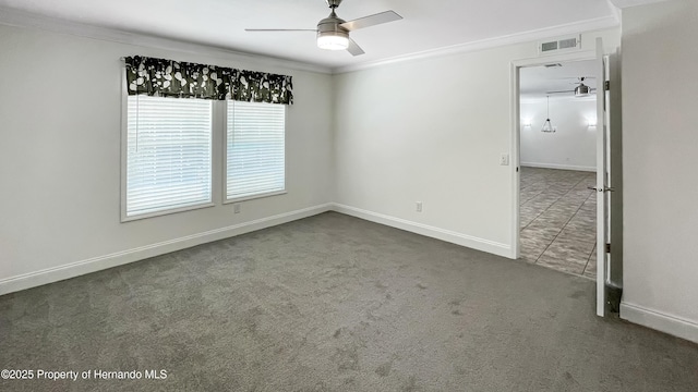 spare room with visible vents, ornamental molding, a ceiling fan, and carpet floors