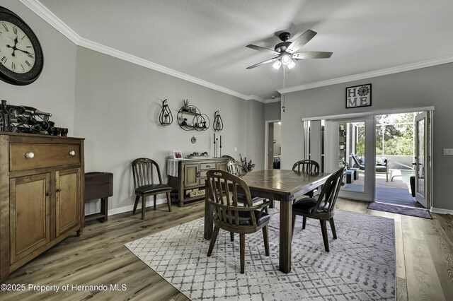 dining space featuring light wood-type flooring and ornamental molding