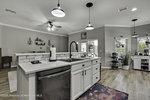 kitchen with visible vents, a center island with sink, a sink, and stainless steel dishwasher