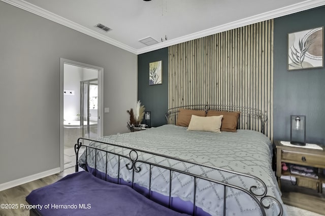 bedroom featuring visible vents, wood finished floors, baseboards, and ornamental molding