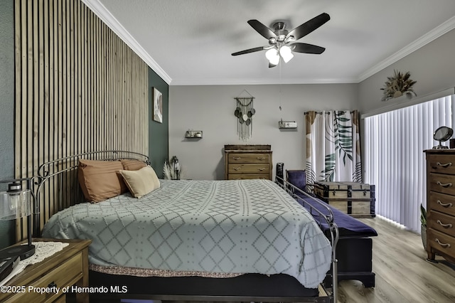 bedroom with a ceiling fan, crown molding, and wood finished floors