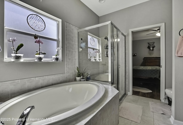 ensuite bathroom featuring ensuite bath, tile patterned flooring, a shower stall, a garden tub, and toilet