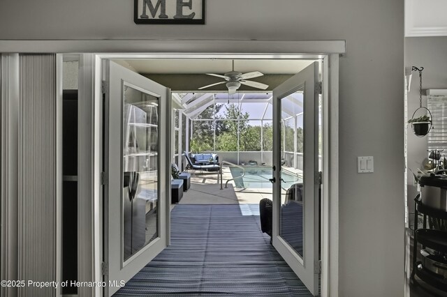 doorway featuring french doors, ceiling fan, and a sunroom