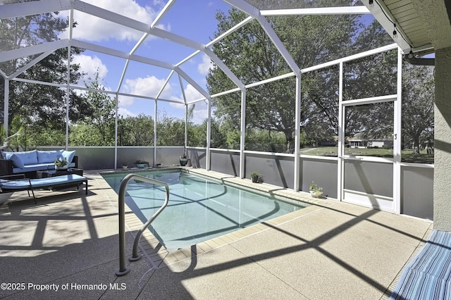 pool with an outdoor living space, glass enclosure, and a patio