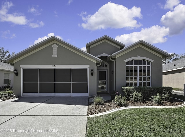 ranch-style home with stucco siding, driveway, and a garage